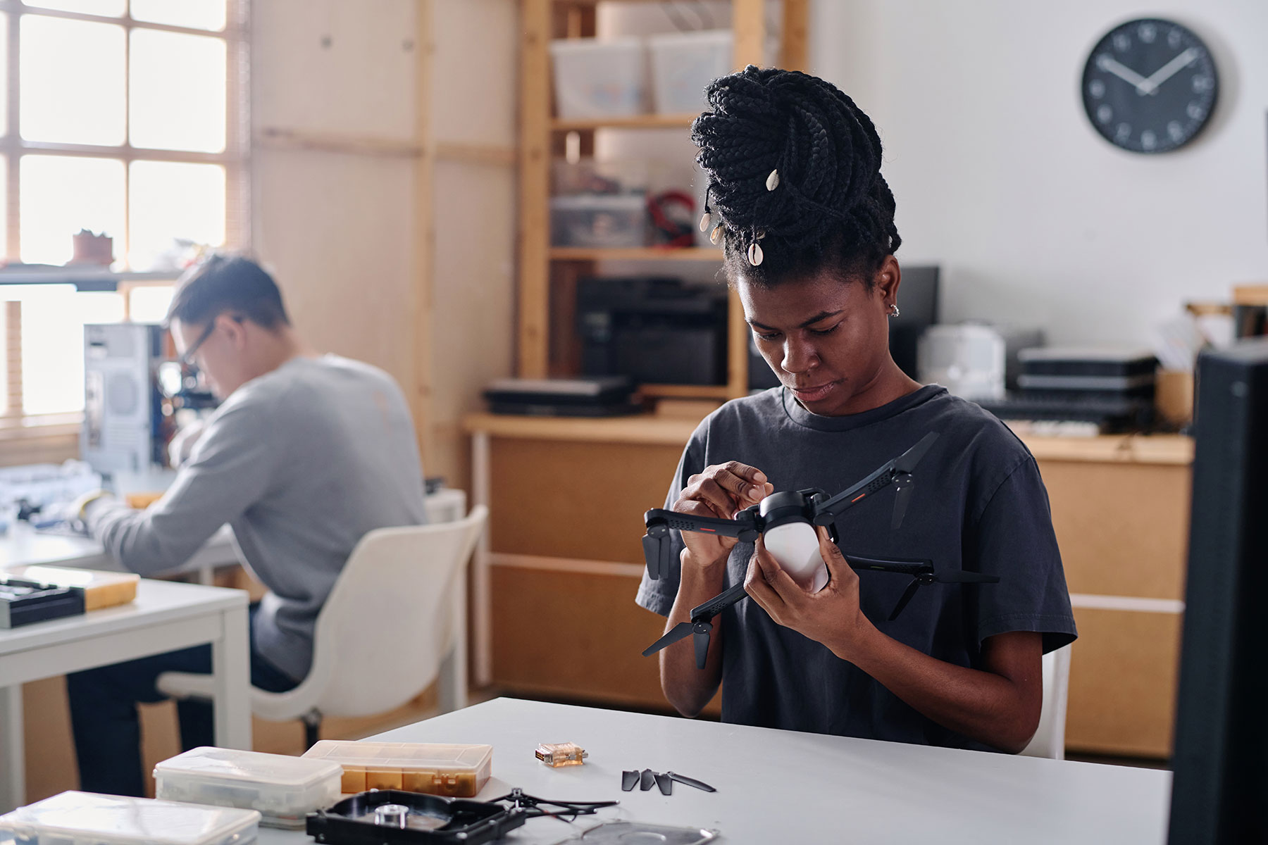 african-american-woman-repairing-quadcopter-in-wor-2024-02-09-03-11-19-utc