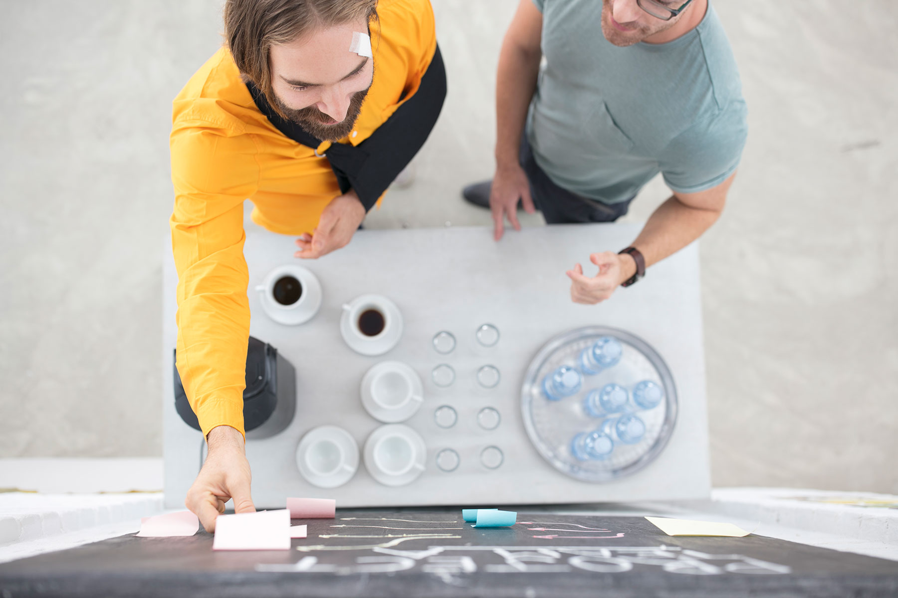 employees-discussing-and-looking-at-notice-board-2024-09-18-17-53-36-utc