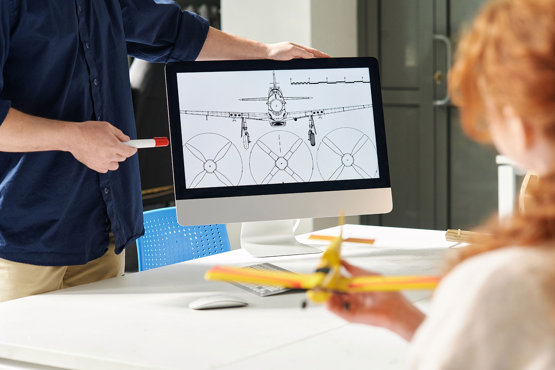 teacher-showing-aircraft-design-chart-2023-11-27-04-59-04-utc